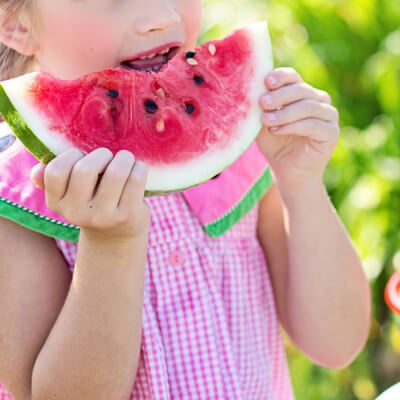 a girl eats a watermelon