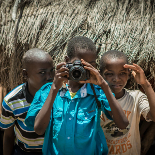 Children taking photos on a camera